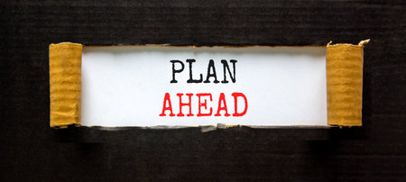 Plan ahead symbol. Concept word Plan ahead on beautiful white paper. Beautiful black paper background. Business plan ahead concept. Copy space.の写真素材