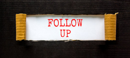 Follow up symbol. Concept word Follow up on beautiful white paper. Beautiful black paper background. Business follow up concept. Copy space.の写真素材