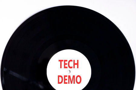 Tech demo symbol. Concept word Tech demo on beautiful black and white vinyl disk. Beautiful white paper background. Business tech demo concept. Copy space.の写真素材