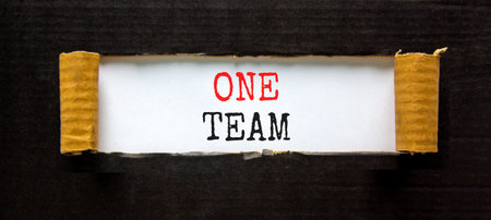 One team symbol. Concept word One team on beautiful white paper. Beautiful black paper background. Business one team concept. Copy space.の写真素材