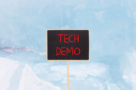Tech demo symbol. Concept word Tech demo on beautiful black blackboard. Beautiful Baikal blue ice and snow background. Black blackboard. Business tech demo concept. Copy space.の写真素材