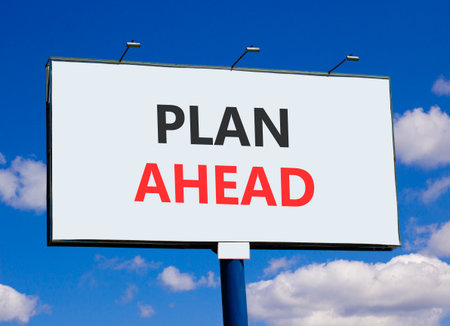 Plan ahead symbol. Concept word Plan ahead on beautiful white billboard. Beautiful blue sky and clouds background. Business plan ahead concept. Copy space.の写真素材