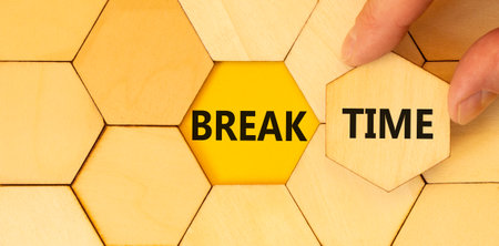 Break time symbol. Concept Break word time on beautiful wooden puzzles. Businessman's hand....