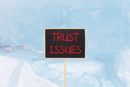 Trust issues symbol. Concept word Trust issues on beautiful black blackboard. Beautiful Baikal blue...