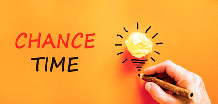 Chance time symbol. Concept word Chance time on beautiful orange paper. Businessman's hand. Light bulb icon. Beautiful orange paper background. Business chance time concept. Copy space.の写真素材