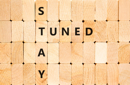 Stay tuned symbol. Concept words Stay tuned on beautiful wooden block wall. Beautiful wooden background. Wooden blocks. Business, support, motivation, psychological and stay tuned concept. Copy space.の写真素材