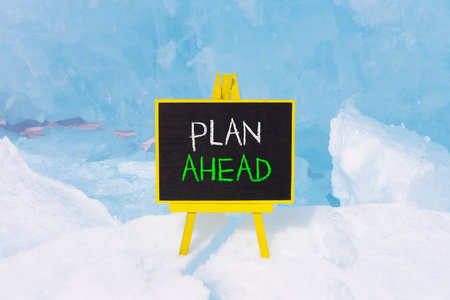 Plan ahead symbol. Concept word Plan ahead on beautiful black blackboard. Beautiful Baikal blue ice and snow background. Black blackboard. Business plan ahead concept. Copy space.の写真素材