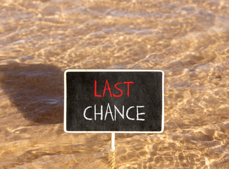 Last chance symbol. Concept word Last chance on beautiful black blackboard. Beautiful Red sea water background. Black blackboard. Business last chance concept. Copy space.の写真素材
