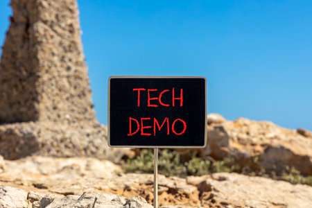 Tech demo symbol. Concept word Tech demo on beautiful black blackboard. Beautiful stone and blue sky background. Black blackboard. Business tech demo concept. Copy space.の写真素材