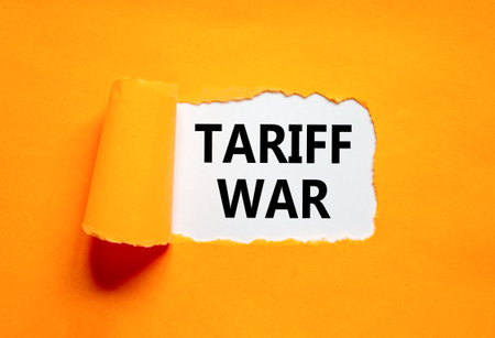 Trade tariff war symbol. Concept word Tariff war on beautiful white paper. Beautiful orange paper background. Business trade tariff wars concept. Copy space.の写真素材