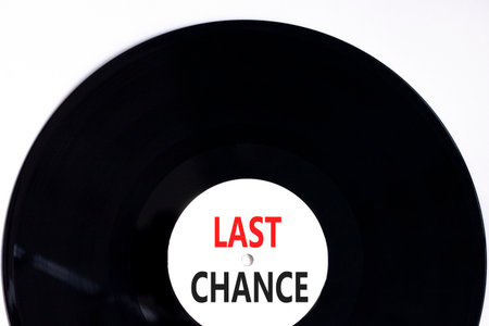 Last chance symbol. Concept word Last chance on beautiful black and white vinyl disk. Beautiful white paper background. Business last chance concept. Copy space.の写真素材