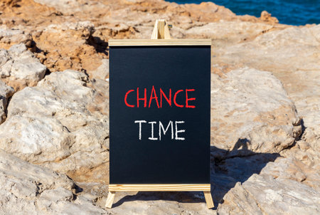 Chance time symbol. Concept word Chance time on beautiful black blackboard. Beautiful stone and blue...