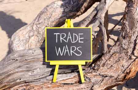 Trade wars symbol. Concept word Trade wars on beautiful black blackboard. Beautiful old tree background. Black blackboard. Business trade wars concept. Copy space.の写真素材
