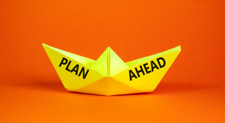 Plan ahead symbol. Concept word Plan ahead on beautiful yellow paper boat. Beautiful orange paper background. Business plan ahead concept. Copy space.の写真素材