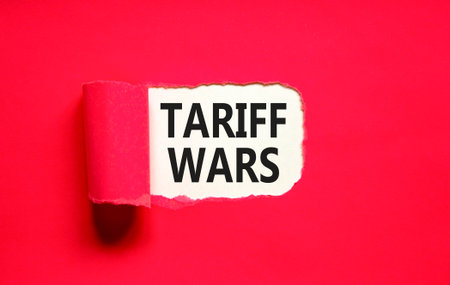 Trade tariff wars symbol. Concept word Tariff wars on beautiful white paper. Beautiful red paper background. Business trade tariff wars concept. Copy space.の写真素材