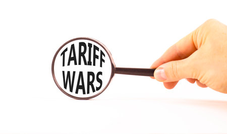 Trade tariff wars symbol. Concept word Tariff wars on beautiful magnifying glass. Businessman's...
