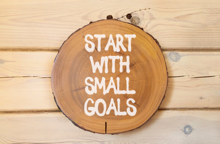 Start with small goals symbol. Concept words phrase Start with small goals on beautiful wooden...