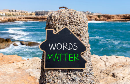 Words matter symbol. Concept word Words matter on beautiful black blackboard. Beautiful stone and blue sea sky background. Black blackboard. Business words matter concept. Copy space.の写真素材