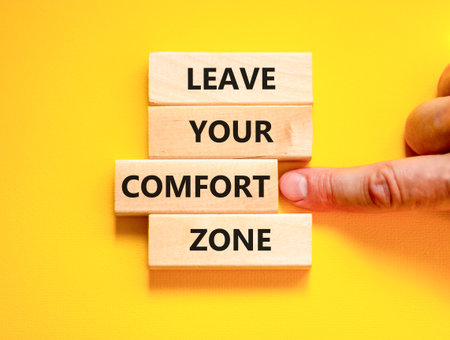 Leave your comfort zone symbol. Concept words Leave your comfort zone on beautiful wooden blocks. Beautiful yellow paper background. Business psychological Leave your comfort zone concept. Copy space.の写真素材