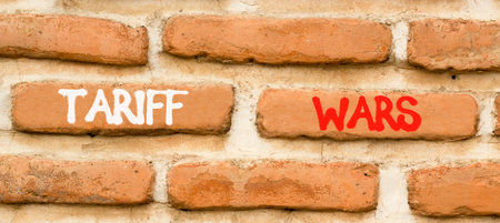 Trade tariff wars symbol. Concept word Tariff wars on beautiful old brown brick wall. Beautiful old brown brick wall background. Old brick wall. Business trade tariff wars concept. Copy space.の写真素材