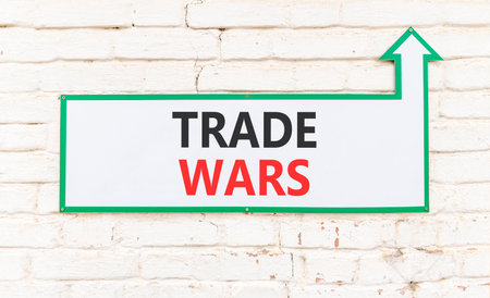 Trade wars symbol. Concept word Trade wars on beautiful white sign on white brick wall. Beautiful white brick wall background. Business trade wars concept. Copy space.の写真素材