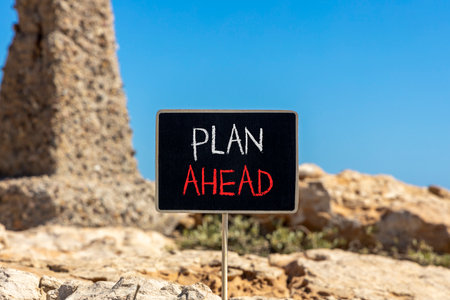 Plan ahead symbol. Concept word Plan ahead on beautiful black blackboard. Beautiful stone and blue sky background. Black blackboard. Business plan ahead concept. Copy space.の写真素材