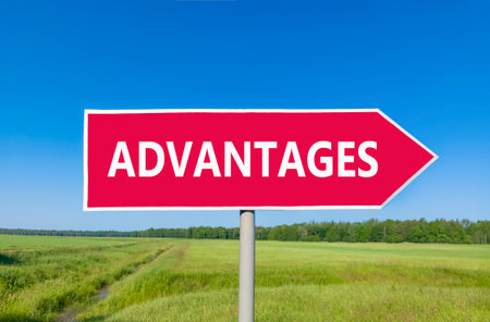 Advantages symbol. Concept word Advantages on beautiful red road sign. Beautiful blue sky green grass and forest peaceful nature background. Business advantages concept. Copy space.の写真素材