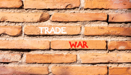 Trade war symbol. Concept word Trade war on beautiful old brown brick wall. Beautiful old brown brick wall background. Old brick wall. Business trade war concept. Copy space.の写真素材
