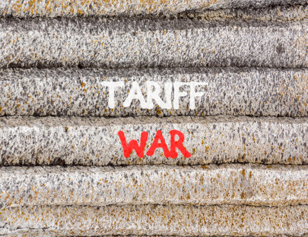 Trade tariff war symbol. Concept word Tariff war on beautiful gray mountain wall. Beautiful gray...