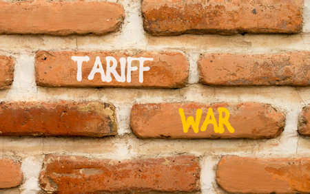 Trade tariff war symbol. Concept word Tariff war on beautiful old brown brick wall. Beautiful old brown brick wall background. Old brick wall. Business trade tariff wars concept. Copy space.の写真素材