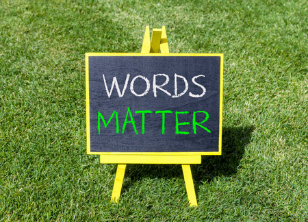 Words matter symbol. Concept word Words matter on beautiful black blackboard. Beautiful green grass lawn background. Black blackboard. Business words matter concept. Copy space.の写真素材