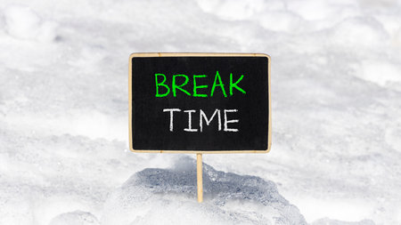 Break time symbol. Concept Break word time on beautiful black blackboard. Beautiful white snow background. White snow. Black blackboard. Business break time concept. Copy space.の写真素材