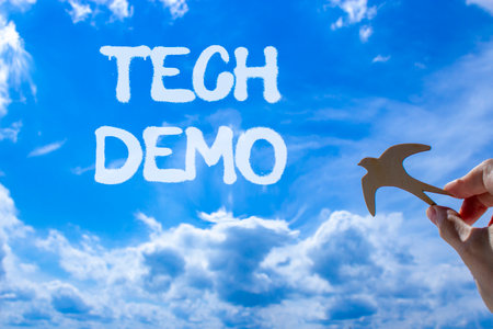 Tech demo symbol. Concept word Tech demo on beautiful blue sky. Businessman's hand with wooden bird. Beautiful blue sky and cloud background. Business tech demo concept. Copy space.の写真素材
