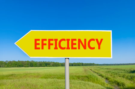 Efficiency symbol. Concept word Efficiency on beautiful yellow road sign. Beautiful blue sky green grass and forest peaceful nature background. Business efficiency concept. Copy space.の写真素材