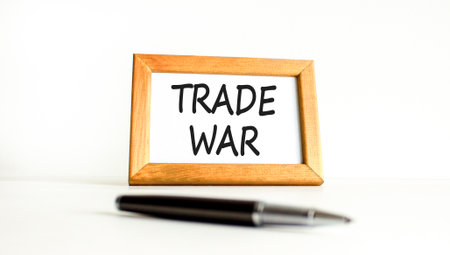 Trade war symbol. Concept word Trade war on beautiful wooden picture frame. Black pen. Beautiful white paper background. Business trade war concept. Copy space.の写真素材
