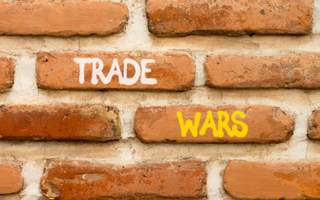 Trade wars symbol. Concept word Trade wars on beautiful old brown brick wall. Beautiful old brown brick wall background. Old brick wall. Business trade wars concept. Copy space.の写真素材