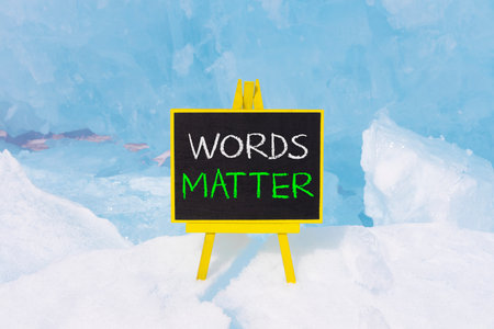 Words matter symbol. Concept word Words matter on beautiful black blackboard. Beautiful Baikal blue ice and snow background. Black blackboard. Business words matter concept. Copy space.の写真素材