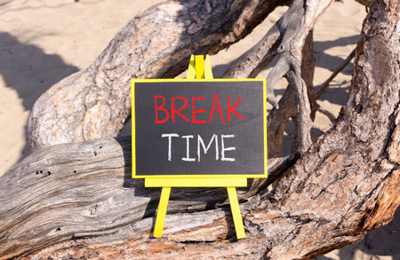 Break time symbol. Concept Break word time on beautiful black blackboard. Beautiful old tree background. Black blackboard. Business break time concept. Copy space.の写真素材