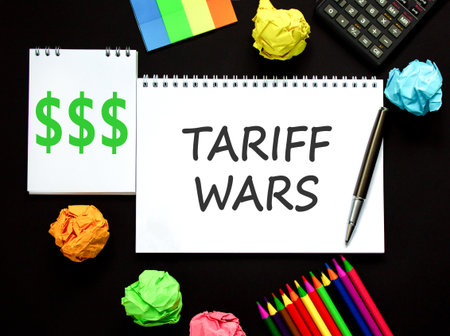 Trade tariff wars symbol. Concept word Tariff wars on beautiful white note. Black calculator. Black pen. Beautiful black paper background. Business trade tariff wars concept. Copy space.の写真素材