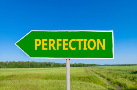 Perfection symbol. Concept word Perfection on beautiful green road sign. Beautiful blue sky green grass and forest peaceful nature background. Business perfection concept. Copy space.の写真素材