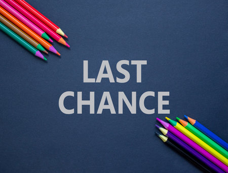 Last chance symbol. Concept word Last chance on beautiful black paper. Colored pencils. Beautiful black paper background. Business last chance concept. Copy space.の写真素材
