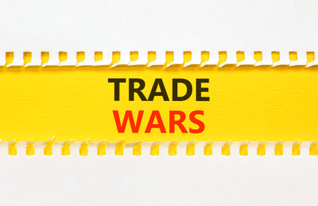 Trade wars symbol. Concept word Trade wars on beautiful white paper. Beautiful yellow paper background. Business trade wars concept. Copy space.の写真素材