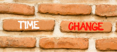 Time change symbol. Concept word Time change on beautiful old brown brick wall. Beautiful old brown brick wall background. Old brick wall. Business time change concept. Copy space.の写真素材