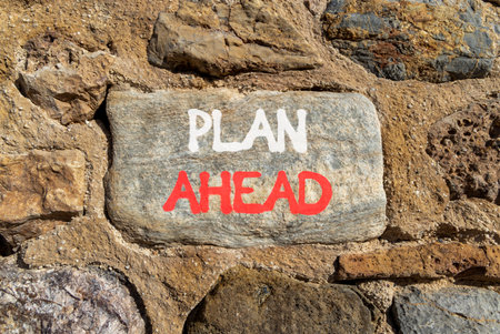 Plan ahead symbol. Concept word Plan ahead on beautiful gray stone on stone wall. Beautiful stone wall background. Business plan ahead concept. Copy space.の写真素材