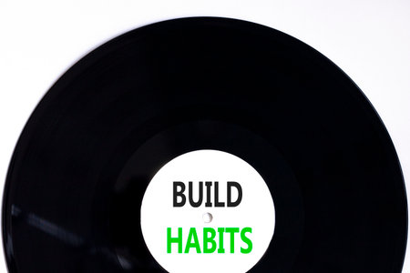 Build habits symbol. Concept word Build habits on beautiful black and white vinyl disk. Beautiful white paper background. Business build habits concept. Copy space.の写真素材