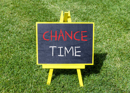 Chance time symbol. Concept word Chance time on beautiful black blackboard. Beautiful green grass lawn background. Black blackboard. Business chance time concept. Copy space.の写真素材