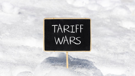 Trade tariff wars symbol. Concept word Tariff wars on beautiful black blackboard. Beautiful white...