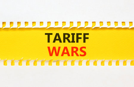 Trade tariff wars symbol. Concept word Tariff wars on beautiful white paper. Beautiful yellow paper...