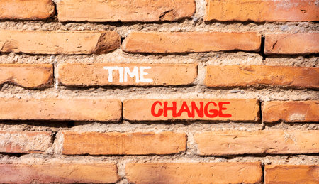 Time change symbol. Concept word Time change on beautiful old brown brick wall. Beautiful old brown...