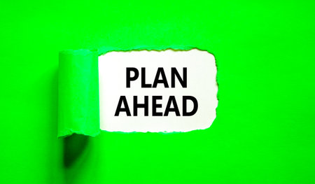 Plan ahead symbol. Concept word Plan ahead on beautiful white paper. Beautiful green paper background. Business plan ahead concept. Copy space.の写真素材